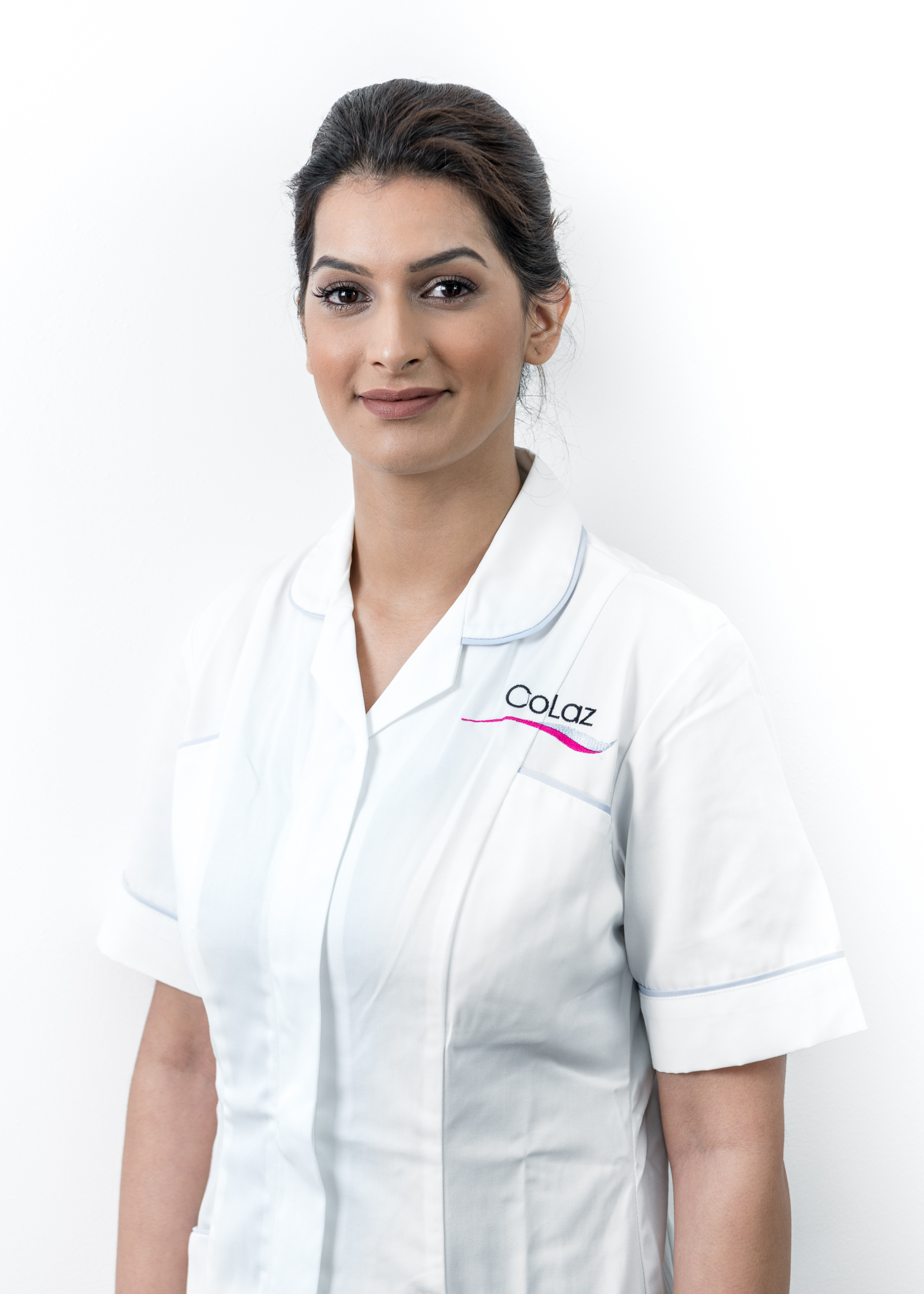 Alayika Parvez, coLaz owner, portrait in branded clinician uniform